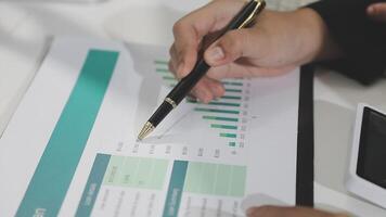 Businessman using pen to write on paper video