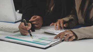 Two people working on a document with a pen and paper video