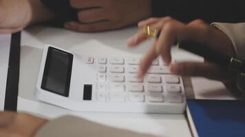 A person using a calculator to calculate a number video