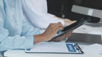 A person is using a tablet while sitting at a desk video