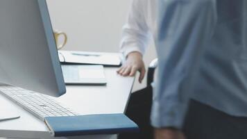 A man is standing next to a computer monitor video