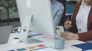 A woman is using her phone while sitting at a desk video