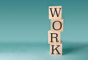 Stack of wooden blocks with the word work written on them photo