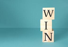 Stack of wooden blocks with the word WIN written on them photo