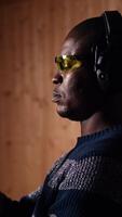 Vertical Portrait of happy shooting range customer reloading pistol, shooting targets, having fun. Close up of joyous man at shooting ground facility loading pistol, wearing protection goggles, camera A video