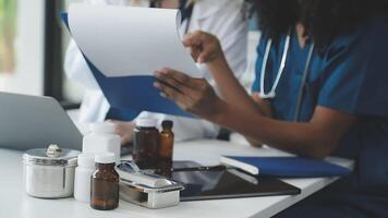 Two doctors are working on a document together video