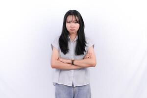 a woman with her arms crossed standing in front of a white background photo
