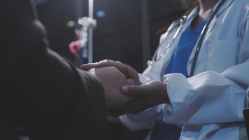 A doctor shaking hands with another person video
