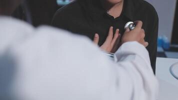 A woman is holding a stethoscope to her chest video