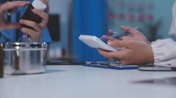 A doctor is using a cell phone while another person is using a pen video