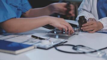 Two doctors working on a computer and a stethoscope video