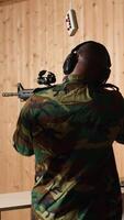 Vertical Team of soldiers wearing uniform in firing range doing shooting course to elevate marksmanship skills. Military units in shooting gallery using weapons to engage targets at various ranges, camera A video