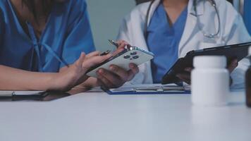 Two doctors using a tablet computer and a bottle video