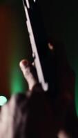 Vertical Man holding pistol enjoying recreational indoor shooting experience in firing range facility, close up. Person practicing with handgun in safe environment at shooting range company, camera B video