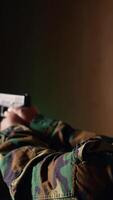 Vertical Portrait of happy soldier holding assault rifle, developing marksmanship skills in firing range. Joyous military unit wearing uniform practices with semiautomatic weapon, camera B video
