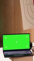 Vertical Mockup laptop next to soldiers in shooting range training discussing about weapons. Isolated screen notebook in firing range next to military units having conversation, camera B video