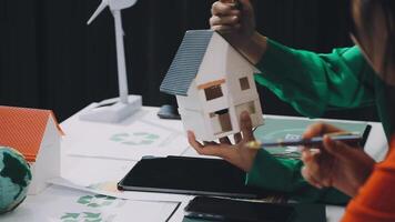 A woman is holding a model house on a table video