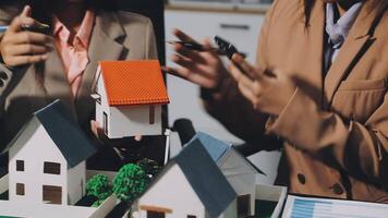 Two people are holding a model of a house video