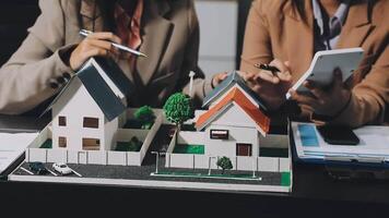 Two people looking at a model of a house video