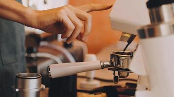 A person is using an espresso machine to make coffee video