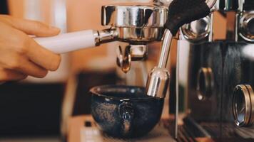 A person is using an espressor to make coffee video