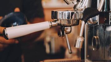 A person is using an espressor machine to make coffee video