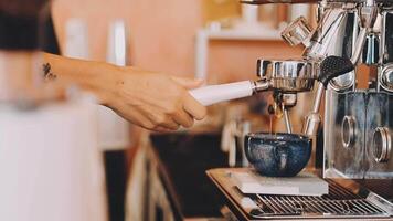 A person is using an espressor to make coffee video