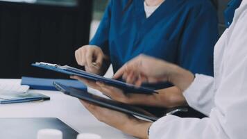 Two doctors are working on a tablet video