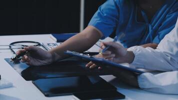 Two doctors are working on a laptop video