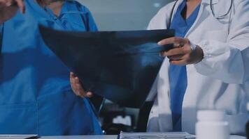 Two doctors are looking at a piece of paper video