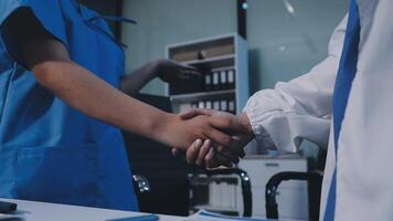 Two doctors shaking hands in an office video