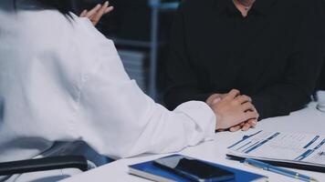 A doctor and patient sitting at a desk video
