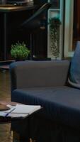 Vertical Cozy apartment with modern decor and trendy electronics creating a relaxation space, stylish minimalist studio loft with a smart tv and a coffee table. Comfortable home with indoor plants. video