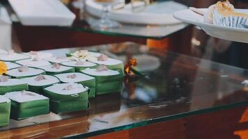 A table with several small cakes on it video