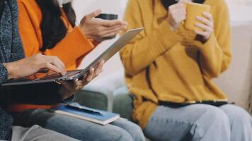 Three people sitting on a couch with laptops video