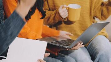 A group of people sitting on a couch with laptops video