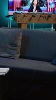 Vertical Cozy modern apartment decorated with neon lights and a big tv, home theatre and setup for a young adult. Empty loft studio illuminated and equipped with electronics, comfortable space. video