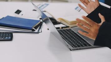 A person sitting at a desk with their hands outstretched video