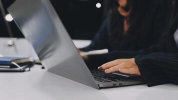 A person typing on a laptop computer video