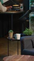 Vertical Ambitious black man learning a new language alone in his cozy living room, browsing internet for study platforms and explanations. Adult using language learning software online on laptop. Camera A. video