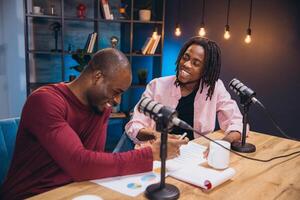 Two cheerful podcasters recording a new episode in a professional studio, discussing and analyzing data and statistics photo