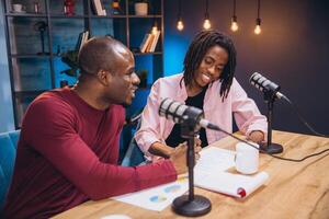 Two podcasters engaging in a lively discussion while recording a new episode in a modern, professional studio setting photo
