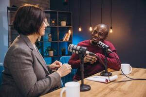 Podcasters engaging in lively conversation during a dynamic live recording session in a modern studio environment photo