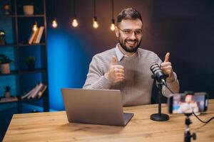 Happy podcaster giving a thumbs up while recording engaging content in a home studio, surrounded by modern technology and creativity photo