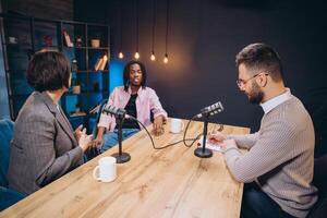 Podcasters interviewing a guest in a professional studio, engaging in insightful conversations and sharing their expertise with their audience photo