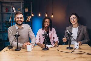 Podcasters discussing animatedly during recording session, surrounded by professional audio gear in contemporary studio setting photo
