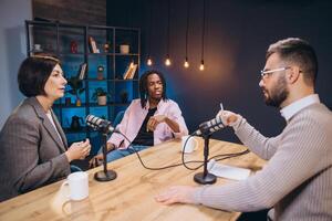 Podcasters interviewing a guest in a studio, discussing interesting topics and sharing their expertise with microphones photo