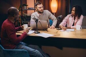 Three radio hosts recording a podcast in a professional studio, engaging in discussion and sharing insights with their audience photo