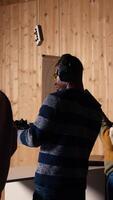 Vertical Company coworkers enjoying recreational shooting experience in firing range during teambuilding. Workplace colleagues practicing with weapons in safe shooting range environment, camera A video