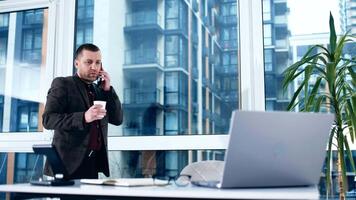 Businessman using laptop in office. Happy middle aged man, entrepreneur, small business owner working online. Using computer remote studying, virtual training video